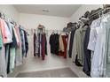 Organized walk-in closet featuring shelving and hanging rods for ample storage at 1004 Whipcord Dr, Waxhaw, NC 28173