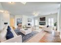 Spacious living room filled with natural light, neutral furniture, and a cozy fireplace at 10123 Barrands Ln, Charlotte, NC 28278