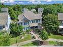 Beautiful aerial view of a two-story house with a well-maintained yard and surrounded by lush trees at 1569 Benjamen Latrobe Cir, Fort Mill, SC 29708