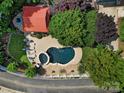 Aerial view of a private backyard oasis featuring a swimming pool, hot tub, gazebo, and lush landscaping at 1569 Benjamen Latrobe Cir, Fort Mill, SC 29708