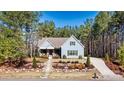 Beautiful two story blue home with lovely landscaping and a concrete driveway at 188 Winding Forest Dr, Troutman, NC 28166