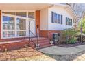 Inviting front porch featuring brick steps, black railings, and a welcoming entrance with ample natural light at 2300 Highlawn Dr, Charlotte, NC 28212