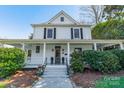 Inviting two-story home featuring a classic white facade, covered porch, and symmetrical window design at 234 N Race St, Statesville, NC 28677