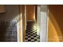 Hallway with black and white checkered flooring and orange walls at 2501 Booker Ave, Charlotte, NC 28216