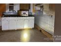 Basic kitchen with white cabinets and laminate countertops at 2501 Booker Ave, Charlotte, NC 28216