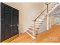 Inviting foyer featuring a staircase, hardwood floors, and natural light at 2825 Sharon View Rd, Charlotte, NC 28210
