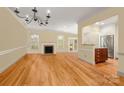 Spacious living room with hardwood floors, fireplace, and open kitchen area at 2825 Sharon View Rd, Charlotte, NC 28210