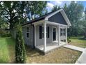 Charming single-story home with gray siding, black shutters, and a welcoming front porch at 347 Sidney St, Rock Hill, SC 29730