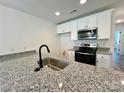 Beautiful kitchen featuring granite counters, stainless steel appliances, and a stylish black faucet at 347 Sidney St, Rock Hill, SC 29730