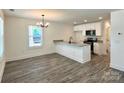 Modern kitchen featuring gray floors, stainless steel appliances, granite countertops, and a center island at 347 Sidney St, Rock Hill, SC 29730
