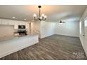 Open-concept living space with modern lighting, gray floors, and a seamless transition to the kitchen at 347 Sidney St, Rock Hill, SC 29730