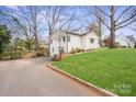 Well-maintained home featuring a long driveway and lush green lawn at 4329 Castleton Rd, Charlotte, NC 28211