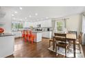 Bright kitchen featuring a center island, modern white cabinets, and stainless steel appliances at 4329 Castleton Rd, Charlotte, NC 28211