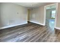 Spacious Living Room featuring wood floors and neutral paint, with doorways leading to other rooms at 507 E Maple Ave, Gastonia, NC 28054