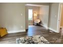 Bright living room featuring wood floors, neutral walls, and ample natural light streaming through the window at 507 E Maple Ave, Gastonia, NC 28054