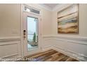 Welcoming entryway with paneled walls, a glass front door, and decorative wall art at 6275 Tea Olive Dr # 176, Harrisburg, NC 28075