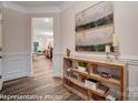 Elegant hallway with crown molding, wood floors, and decorative console table at 6275 Tea Olive Dr # 176, Harrisburg, NC 28075