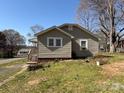 Cozy home exterior with green lawn, showcasing siding and tree-lined surroundings at 701 Betty St, Gastonia, NC 28054