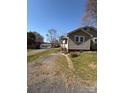 Angle view of home with gravel driveway leading to the side porch entrance at 701 Betty St, Gastonia, NC 28054