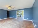 Living room looking into a kitchen space with white cabinets and stainless steel appliances at 82 22Nd Nw Ave, Hickory, NC 28601