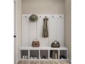 Organized mudroom with built-in bench, storage cubbies, and hooks for coats and bags, blending functionality with style at 8947 Nettleton Ave, Charlotte, NC 28215