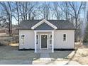 Inviting single-story home with gray vinyl siding, a cozy covered porch, and a decorative wreath on the front door at 925 Park Dr, Statesville, NC 28677