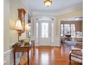 Welcoming foyer with hardwood floors, decorative front door, and elegant lighting at 10432 Bethpage Dr, Indian Land, SC 29707