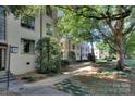 A lush exterior building view features mature trees offering shade and character at 1121 Myrtle Ave # 24, Charlotte, NC 28203