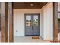 Close up view of the attractive gray double front doors with glass panels and stylish hardware at 1370 Coppergate Dr, Salisbury, NC 28147