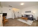 Bright living room featuring hardwood floors, a staircase, and comfortable seating area at 14073 Clayborn St, Midland, NC 28107