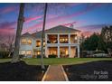 Stunning backyard featuring manicured lawn, spacious patio, and views of a lake at 147 Shelburne Pl, Mooresville, NC 28117