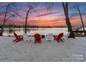Sandy beach featuring Adirondack chairs facing the lake, perfect for relaxing and enjoying the water at 147 Shelburne Pl, Mooresville, NC 28117