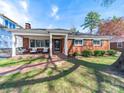 Brick facade with covered porch and classic design elements, offering timeless curb appeal at 1623 Geneva Ct, Charlotte, NC 28209