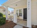 Inviting front porch with white columns and space for seating at 2012 Oakstone Dr, Monroe, NC 28110