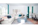 Bright living room featuring a comfortable sectional sofa and teal accents at 203 Giant Oak Ave, Statesville, NC 28677