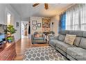 Cozy living room featuring hardwood floors, neutral-toned couches and a decorative area rug at 210 W Lee Ave, Bessemer City, NC 28016