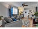 Comfortable living room with ample seating, ceiling fan, and view into the kitchen area at 210 W Lee Ave, Bessemer City, NC 28016