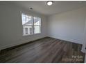 Bright bedroom with large window, hardwood floors, and white trim at 255 Luray Way # 442, Rock Hill, SC 29730