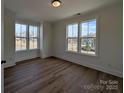 Sunny bedroom with hardwood floors and large windows offering a neighborhood view at 263 Luray Way # 444, Rock Hill, SC 29730