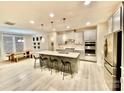 Modern kitchen with stainless steel appliances, a large center island with bar seating, and pendant lighting at 278 W Waterlynn Rd, Mooresville, NC 28117