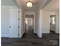 Bright hallway with modern lighting, leading to other rooms with fresh paint and dark wood floors at 279 Luray Way # 448, Rock Hill, SC 29730