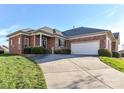 Spacious driveway leading to a brick home with a two-car garage and well-maintained landscaping at 2802 Santiago Cir, Monroe, NC 28110