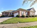 Beautiful brick home with a well-kept lawn, black shutters, attached garage and inviting curb appeal at 2802 Santiago Cir, Monroe, NC 28110