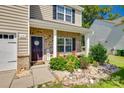 Inviting front porch with seating and landscaping details at 317 Praline Way, Fort Mill, SC 29715