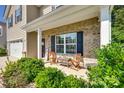 Inviting front porch with chairs and a table, perfect for relaxing at 317 Praline Way, Fort Mill, SC 29715