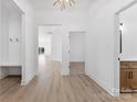 Bright entryway with light hardwood flooring and white walls leading into a large kitchen at 4005 Miller Rd, Salisbury, NC 28147