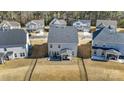 An aerial view shows the home's fenced yard, and patio with outdoor seating, nestled within a residential community at 4208 Stream Dale Nw Cir, Concord, NC 28027