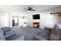 Bright living room with neutral carpet, ceiling fan, and comfortable seating, creating a relaxing atmosphere at 446 Brannon Meadows Dr, York, SC 29745