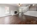 Spacious living room featuring hardwood floors, a cozy fireplace, and plenty of natural light at 507 N Oakland St, Gastonia, NC 28052