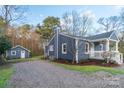 Charming cottage featuring a matching storage shed and lovely landscaping at 6282 Richburg Rd, Great Falls, SC 29055